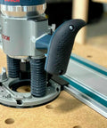 Guide Rail Adapter Fits Bosch 1617 Router Converts Plunge Or Fixed Base To Track Saw System For Dead On Cut Accuracy Uses Original Sub Base Screws For A No Sweat Install Designed And Built In America on router mounted on workbench.