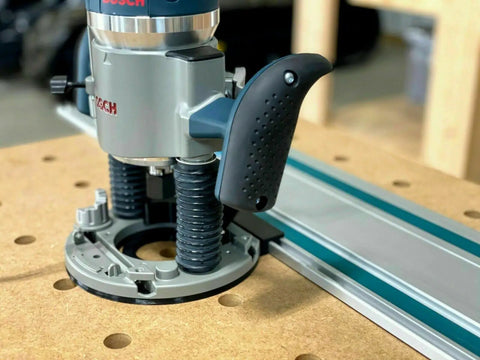 Guide Rail Adapter Fits Bosch 1617 Router Converts Plunge Or Fixed Base To Track Saw System For Dead On Cut Accuracy Uses Original Sub Base Screws For A No Sweat Install Designed And Built In America on router mounted on workbench.