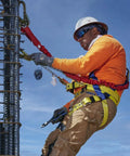 Construction worker in Premium WorkMaster Safety Harness With Tongue Buckles And Three D Rings Polyester Nylon Construction Gear For Go To Fall Protection On Construction And Industrial Job Sites X Large.