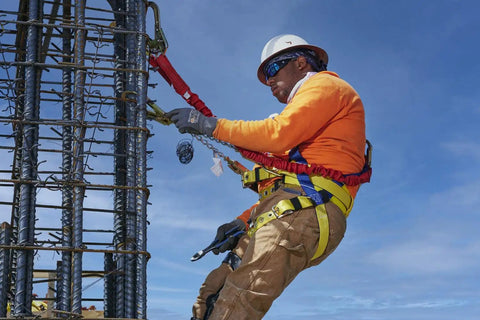Construction worker in Premium WorkMaster Safety Harness With Tongue Buckles And Three D Rings Polyester Nylon Construction Gear For Go To Fall Protection On Construction And Industrial Job Sites X Large.
