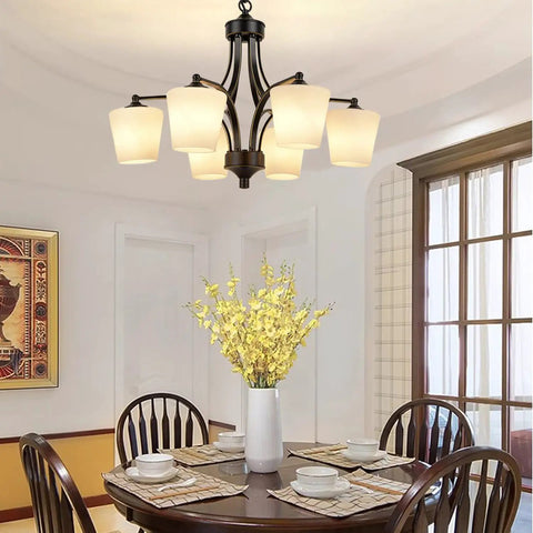 Dining room with Six Light Large Chandelier With Alabaster Glass Shades In Oil Rubbed Bronze Finish over a round table