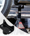 Heavy Duty Bottle Jack Adapter Saddle For Axle Tubes Fits Round 2 Inch, 3 Inch, 4 Inch And Square 2 Inch Axles With 1.5 Inch Lifting Platform, Rugged Lift Accessory Up To 17000 Lbs For Trucks, SUVs And Off Road attached to a jack under a vehicle, with close-up of black adapter.