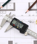 Digital Caliper with Stainless Steel Body, LCD Display, on engineering blueprint showing 6.42 measurement, ideal for DIY
