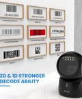 Hands Free 2D Barcode Scanner With USB Desktop Connection Omnidirectional QR Code Reader For POS Supermarket Library Retail And Bookstore Built For Fast Auto Scan And Sleep Wake For Zero Touch Operation on a counter with barcode samples.