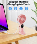 3 In 1 Portable Personal Fan With 4000mAh Battery And LED Display on desk, charging via laptop, pink color