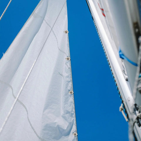 Close-up of sail edge with zinc-alloy eyelet grommets along the seam