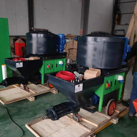 Two Portable Cement Sand Mortar Plastering Sprayer Pumps on pallets in a warehouse setting, designed for wall stucco coating.
