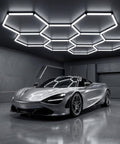 Hexagon LED Garage Lights 210W 25200LM 35 Pack Ultra Bright Ceiling Panels illuminating a car in a modern garage.