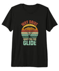 Black tee with "Why Drive When You Can Glide" graphic, suited for paragliding, featuring a colorful retro sunset and paraglider.