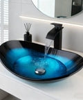 Blue Oval Glass Vessel Sink With Waterfall Faucet And Pop Up Drain Above Counter Bathroom Vessel Sink Artistic Tempered Glass Bowl Modern Dope Boat Shape Design For Stylish Home Renovation with water cascading into the bowl.