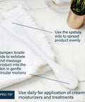 Pore Polishing Wand Silicone Facial Cleansing Brush with dual-sided spatula and bristle on marble surface