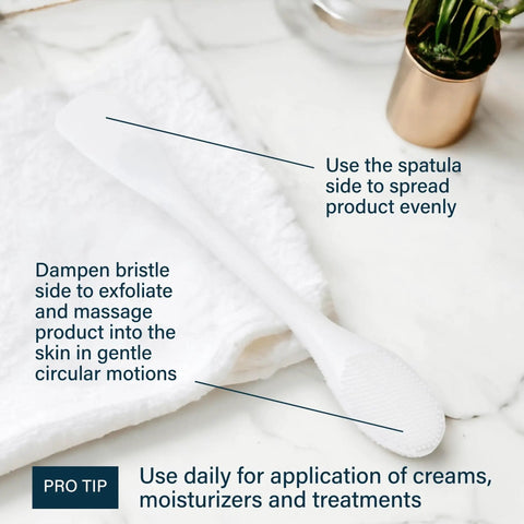 Pore Polishing Wand Silicone Facial Cleansing Brush with dual-sided spatula and bristle on marble surface