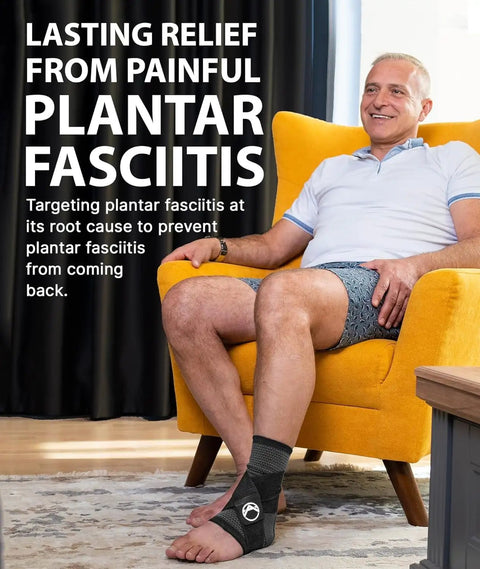 Person wearing Plantar Fasciitis Relief Ankle Compression Sleeve for Women and Men, sitting in a yellow chair, smiling.