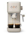 20 Bar Slim Espresso Maker With 1300 Watt Pump And 360 Degree Steam Wand For Silky Microfoam brewing espresso into two glass cups.