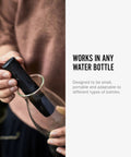 Person inserting Charcoal Water Filter Sticks For Dope Tasting Hydration Inspired By Old Japanese Tradition Lasts Six Months Per Stick Perfect For Your Reusable Water Bottle And Everyday Sips into a glass bottle.