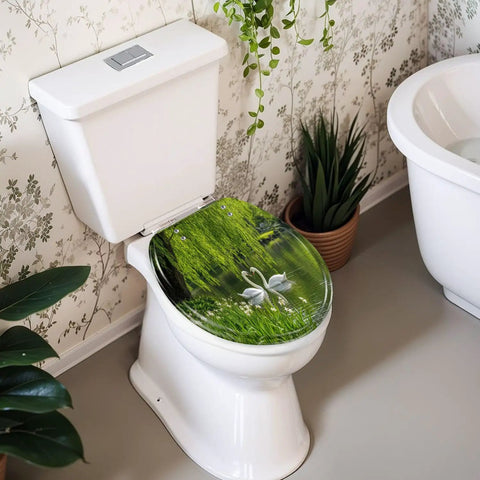 Round Graceful Swans Serene Willow Tree Reflected Calm Pond Toilet Seat on white toilet, showcasing resin material and soft-close hinge.