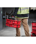 Gutsy Modular Tool Tray For Tradesmen Heavy Duty Plastic Organizer held by worker, red color, designed for job site tool organization.