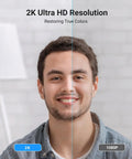 Split image showcasing 2K Ultra HD resolution with improved color on left side, person smiling, backdrop of room with lamp.
