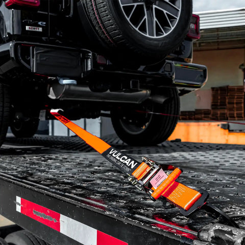 Ultimate Axle Tie Down Kit Pro Series Heavy Duty Webbing with ratchet strap securing vehicle on trailer