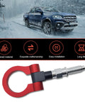 Red Alloy Car Front Bumper Tow Hook With Foldable Design, Rust Proof Recovery Ring For Fast Grab And Go Trail Rescue, Heavy Duty Screw Mount Pull Eye For Muddy Trail Beaters on snowy road with pickup truck.