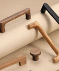 Built Tough Solid White Oak Wood Drawer Knobs For Kitchen Cabinets And Bedroom Dressers Featuring A Modern Single Hole Mount. Various wood handles and knobs on a neutral background.