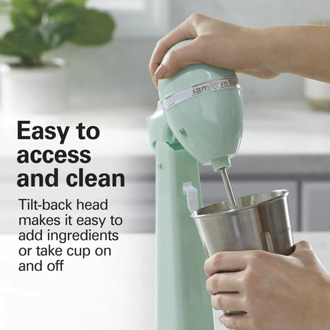 Person using DrinkMaster Electric Drink Mixer For Smoothies And Shakes Retro Milkshake Maker And Milk Frother Two Speeds Extra Large 28 Oz Stainless Steel Cup Mint Finish Quick Whip For Cold Treats And Coffee with tilt-back head.