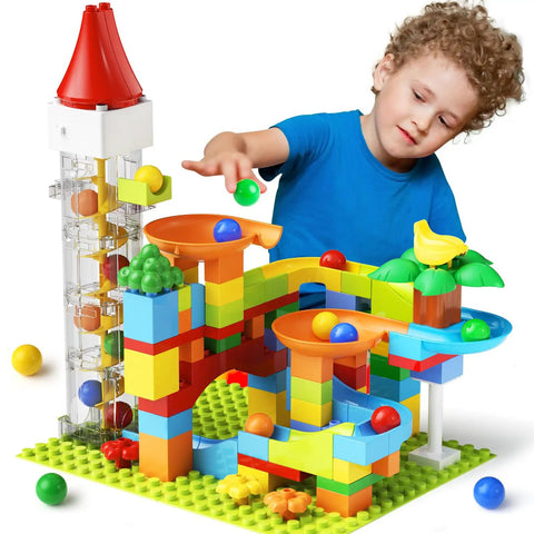 Child playing with Motorized Marble Run Elevator Kit With Perpetual Motion Machine, colorful blocks, and track loops.