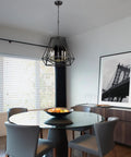 Juliet 1-Light Industrial Chandelier In Matte Black With Open Socket Design above dining table in modern room