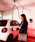 Straight Up Genius For Home EV Charging With This Overhead Retractable Cord Reel Boasting A Spacious 6.6 Foot Reach in a garage.