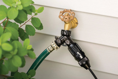 Rain Bird 25 PSI drip irrigation regulator installed on outdoor brass faucet; 3/4" MHT to 3/4" FHT, black body.