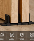 Image of Three Roller Adjustable Floor Guide for siding closet doors and bypass sliding doors, aluminum, black finish installed on wooden floor.