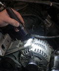 Hand using Strion LED HL 615 Lumen Rechargeable Professional Flashlight With 120V AC Charger Three Modes Plus Strobe in engine bay