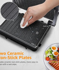 Aigostar Silver 1000W Panini Press Grill With Ceramic Nonstick Plates For Even Cooking Bacon Burgers Chicken Steaks And Reheating Personal Pizza showing easy clean ceramic plates.