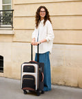 Woman with Your Go To Carry On That Fits Overhead Bins 22x14x9 Inches Water Resistant Softside Spinner With TSA Lock And 3 Pouches
