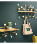 Heavy-Duty Wrought Iron Shell Wall Hooks, Double Robe And Coat Rack For Closets Bathrooms And Entryways, Game-Saving Space Organizer with colorful hooks and shelf.