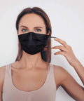 Person wearing IMask Premium ASTM Level 3 Face Mask Black Pack Of 50 With Soft Multilayer Nonwoven Fabric And High Fluid Resistance