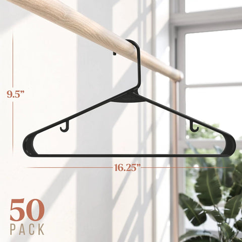 50 Pack Black Plastic Clothes Hangers For Closet Organization And Space Saving, Heavy Duty Coat Hangers For Shirts And Jackets shown on a wooden rod