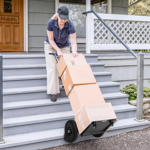 Heavy Duty 1200W Electric Stair Climber Trolley That Hauls Massive Loads Up Steps Like A Boss With Rust Resistant Stainless Steel Deck For Tough Job Sites in use moving boxes up stairs.