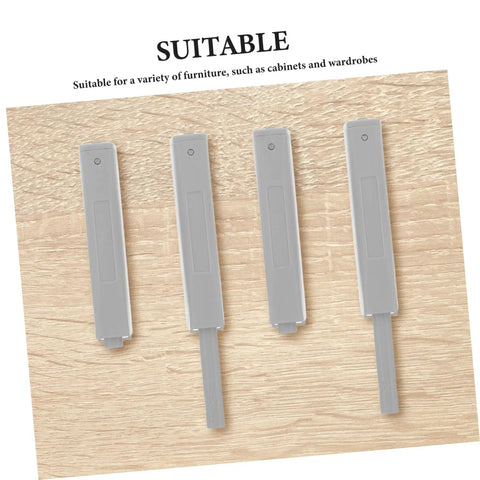 Four Pack No Brainer Push Latch Cabinet Door Catch Hidden Rebound Device set on wooden surface