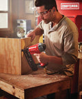 Carpenter using Finish Nailer 16 Gauge Pneumatic With Oil Free Motor in workshop on wooden project.