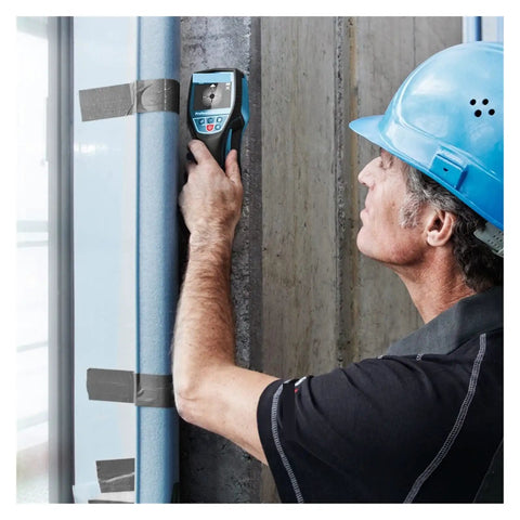 Man using Hands Down Best Pro Grade Wall Scanner to detect hidden obstructions in a concrete wall during renovation.