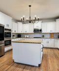 Six Light Black Modern Farmhouse Chandelier With Rustic Vintage Candle Iron Arms in kitchen with white cabinets