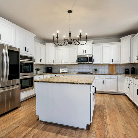 Six Light Black Modern Farmhouse Chandelier With Rustic Vintage Candle Iron Arms in kitchen with white cabinets