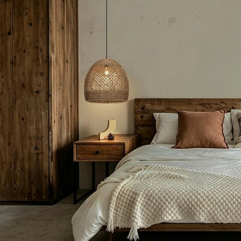 WALMHEIM 15.7" Boho Rattan Pendant Light Fixture over a wooden bedside table in a rustic bedroom setting.