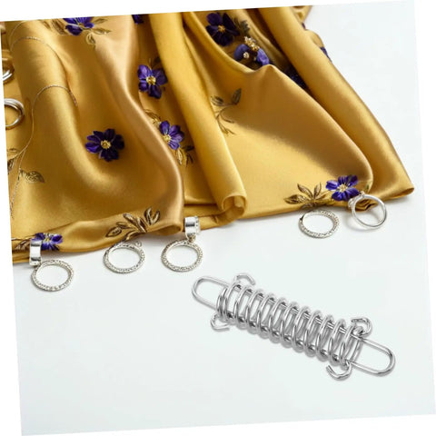 Image of a 3 Piece Adjustable Rope Buckle High Strength Spring Tensioner Set placed beside a floral decorated yellow fabric.