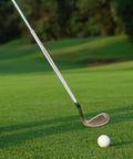 Golf iron with Two Pack Golf Club Extensions Steel Shaft Putter Length Adjustment Tool, on lush green grass, near white golf ball.