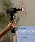 Person holding Sonic LX Heated Massage Gun For Deep Tissue Muscle Recovery with quiet motor in action