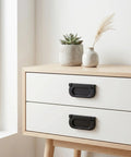 Two Pack Recessed Door Pulls Matte Black Zinc Alloy Flush Handles For Cabinets And Drawers on a light wooden cabinet