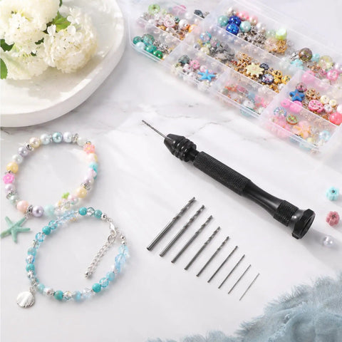Badass Mini Micro Drill Bit Set With Tough Pin Vise And Slick Carburetor Jet Plus Jeweler Twist Bits From Point Five To Three Millimeters laid out with jewelry, beads, and drill bits.