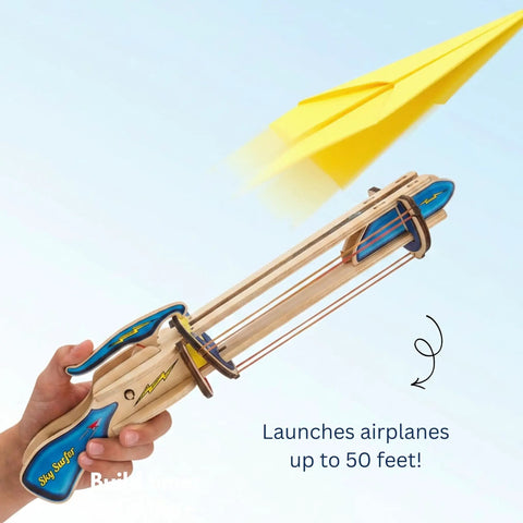 Paper Airplane Launcher STEM Kit For Kids Teens And Adults A Hands On Engineering Project That Lets You Build A Wooden Launcher In About 60 Minutes And Fly Custom Planes While Learning Science, wooden launcher in hand launching yellow paper plane